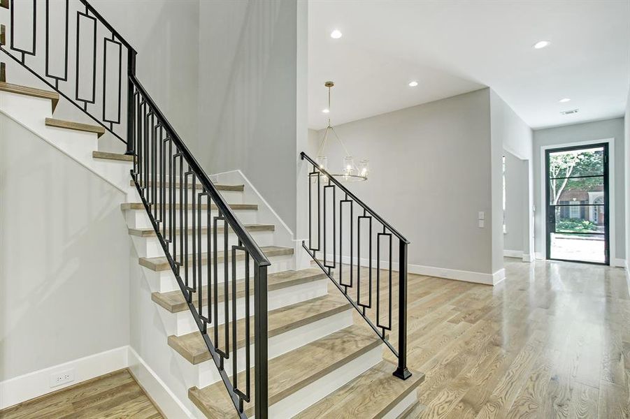 Beautiful iron stairwell.  This great open floorplan has 11' ceilings down and 10' ceilings up. In addition to the beauty you see there are great things you don't see like two 16 SEER A/C units and 2 tankless water heaters.