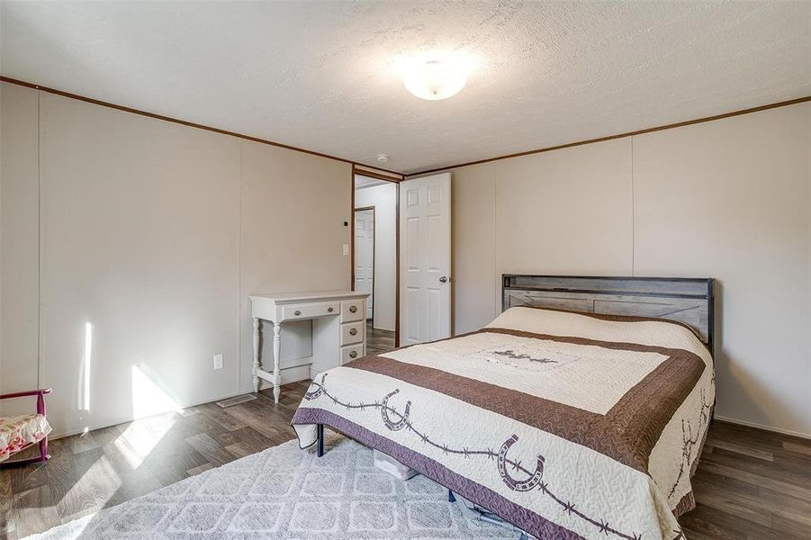 Bedroom featuring dark hardwood / wood-style flooring