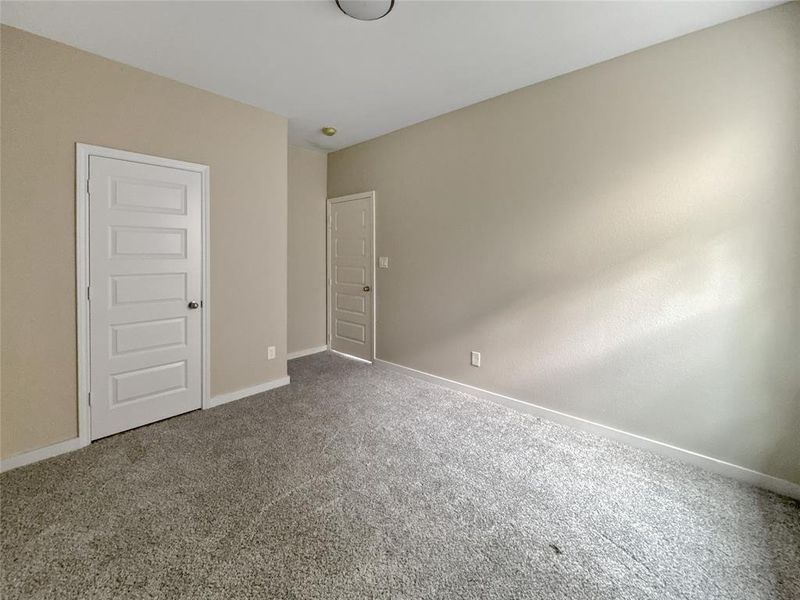Unfurnished bedroom with baseboards and carpet