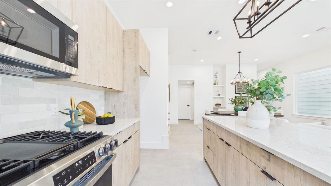 Stainless steel appliances complement the neutral tones of this stunning kitchen.
