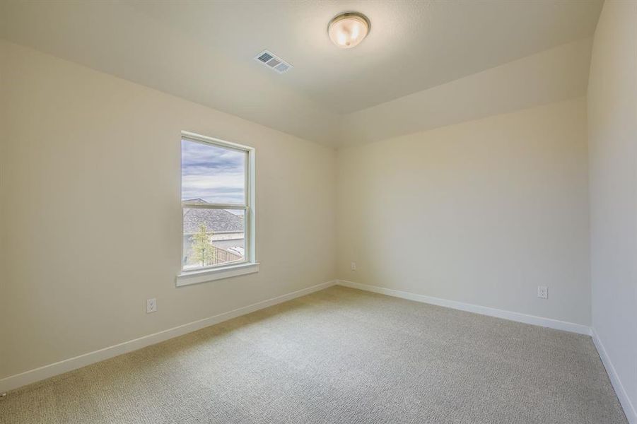 Unfurnished room featuring light carpet and baseboards Unfurnished room featuring light carpet and baseboards