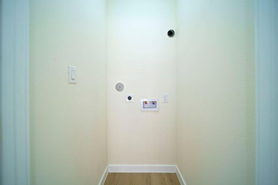 This photo shows a laundry nook with hookups for a washer and dryer. This photo shows a laundry nook with hookups for a washer and dryer.