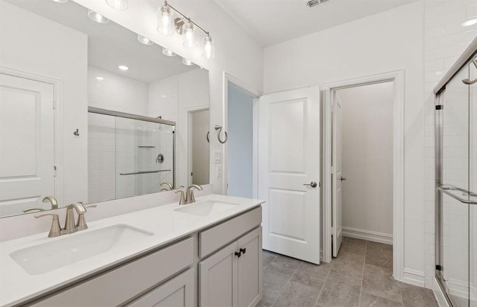 Owner's bath designed with a double vanity and oversized shower *Real home pictured Owner's bath designed with a double vanity and oversized shower *Real home pictured