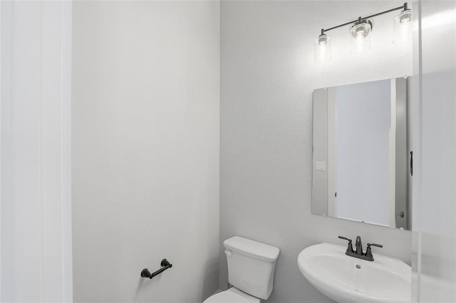 Half bath with toilet and a sink