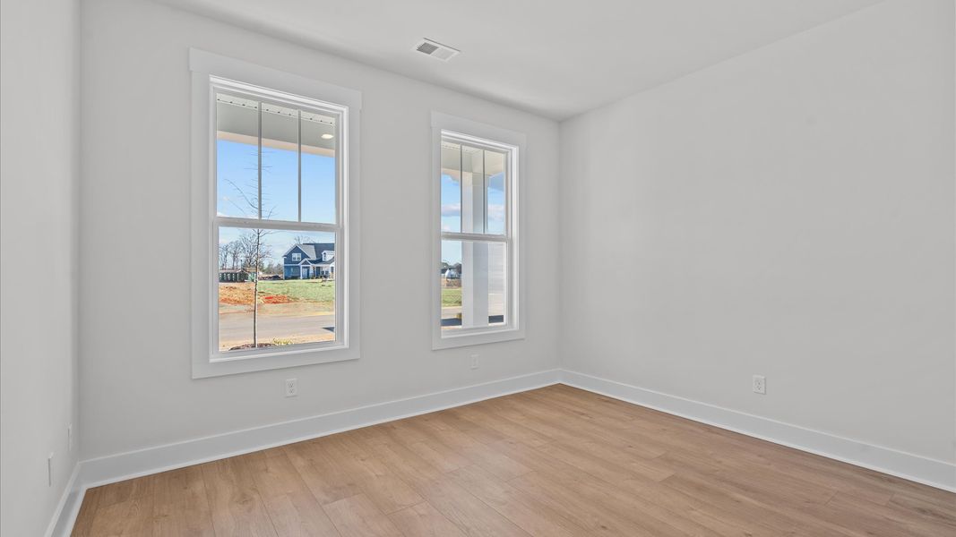 Thoughtfully designed secondary bedrooms featuring hardwood flooring and tasteful detail Thoughtfully designed secondary bedrooms featuring hardwood flooring and tasteful detail