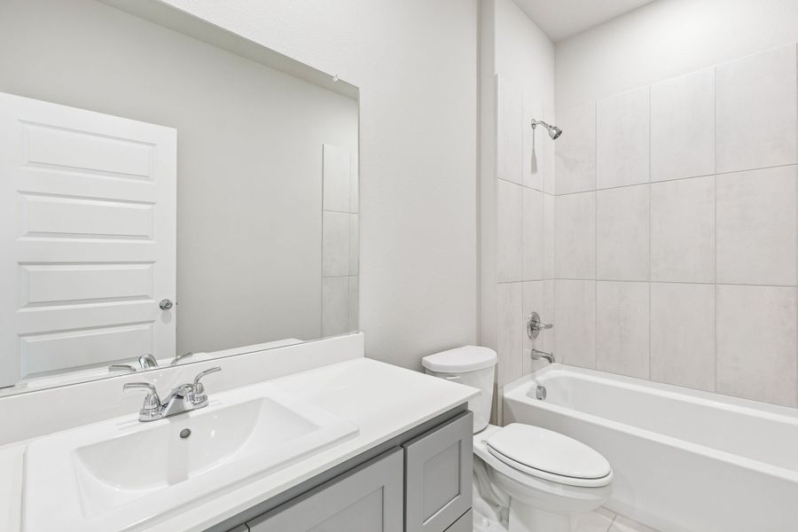 Bathroom in the Haylee home plan by Trophy Signature Homes - REPRESENTATIVE PHOTO