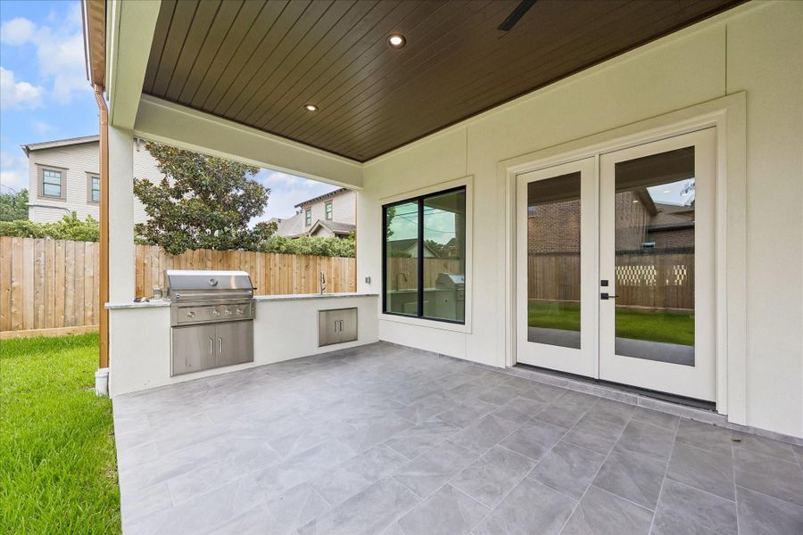 Fire up the built in outdoor kitchen and enjoy year round entertaining beneath the covered patio with a stained wood ceiling and ceiling fan. Direct access from the family room creates a seamless connection between indoor and outdoor living.
