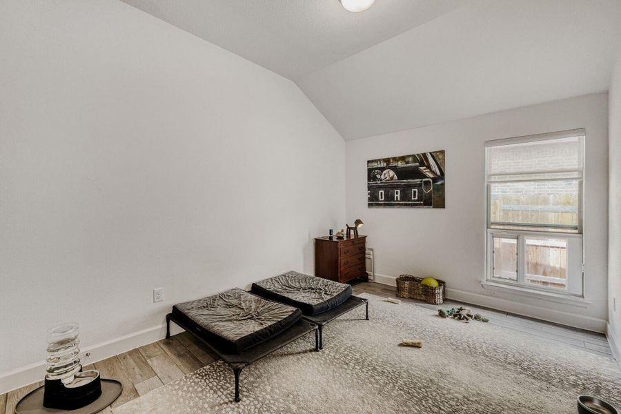 Living area featuring wood finished floors and lofted ceiling