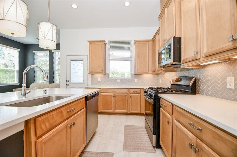 A deep basin farmhouse sink and automatic dishwasher make cleanup a breeze. With plenty of space for your sous chef and cleanup crew, this kitchen is as functional as it is stylish.