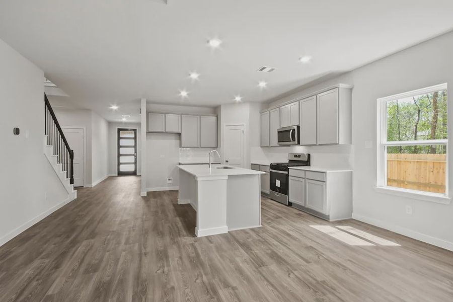 A kitchen with white cabinets.