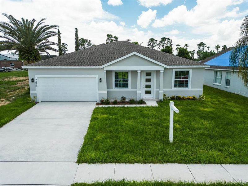 Front exterior of a new home in , Kissimmee, FL, highlighting curb appeal (Image 37).