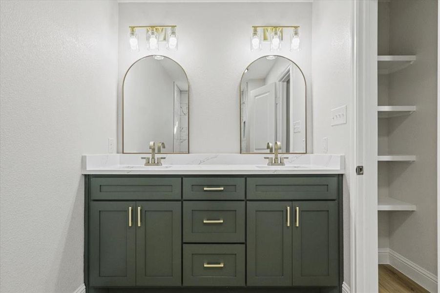 Bathroom with built in features, vanity, and wood-type flooring