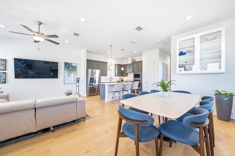 An open floorplan seamlessly connects the dining space to the kitchen and living areas. An open floorplan seamlessly connects the dining space to the kitchen and living areas.
