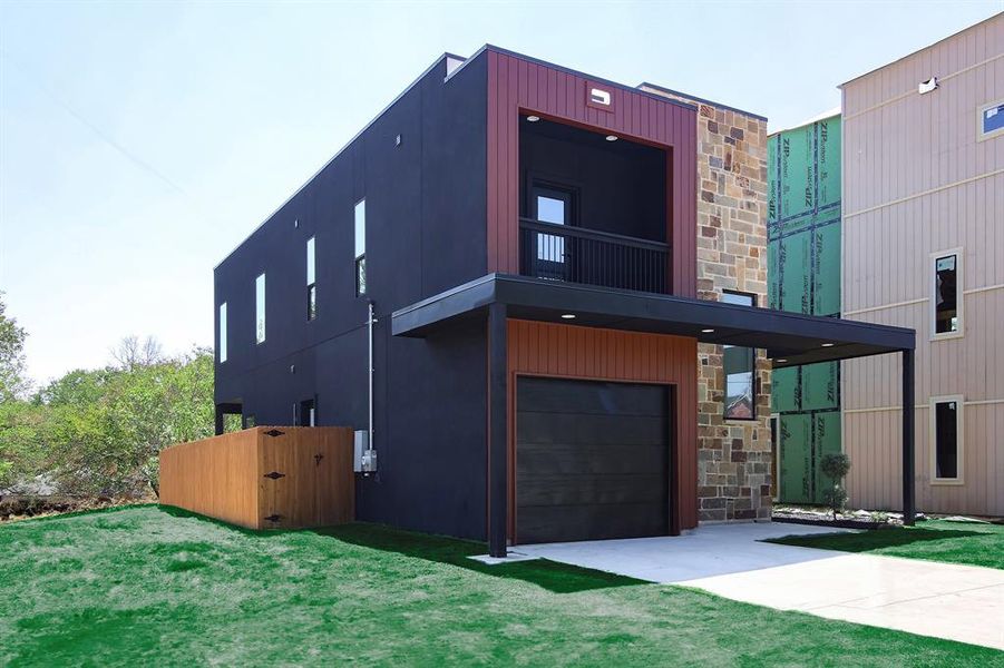 Contemporary home with a front lawn and a garage