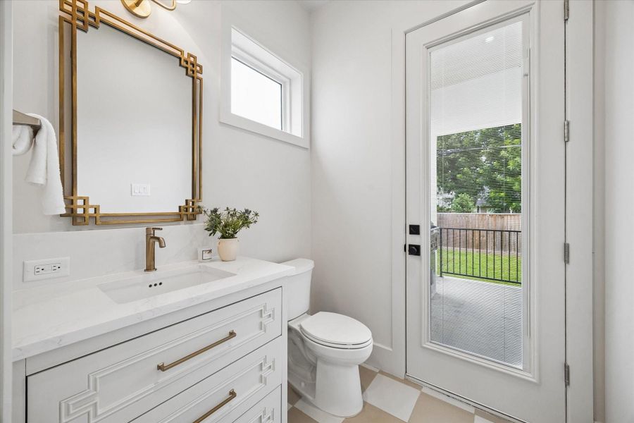 The downstairs powder bath also serves as a convenient pool bath, offering easy access from the outdoor living area. The downstairs powder bath also serves as a convenient pool bath, offering easy access from the outdoor living area.
