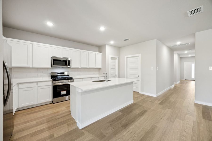Kitchen in the Oscar home plan by Trophy Signature Homes – REPRESENTATIVE PHOTO Kitchen in the Oscar home plan by Trophy Signature Homes – REPRESENTATIVE PHOTO