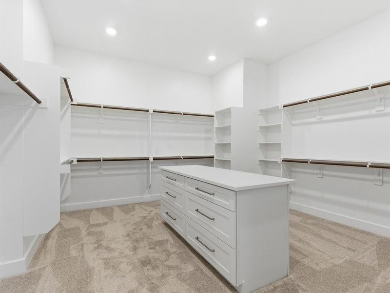 Walk in closet featuring light colored carpet