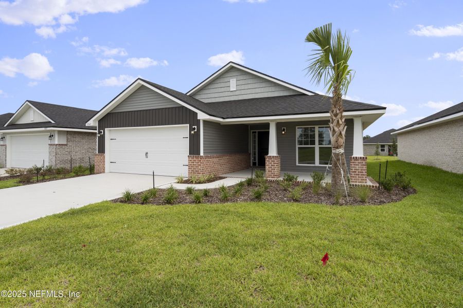 Front exterior of a new home in Shadow Crest at Rolling Hills, Green Cove Springs, FL, highlighting curb appeal (Image 14).