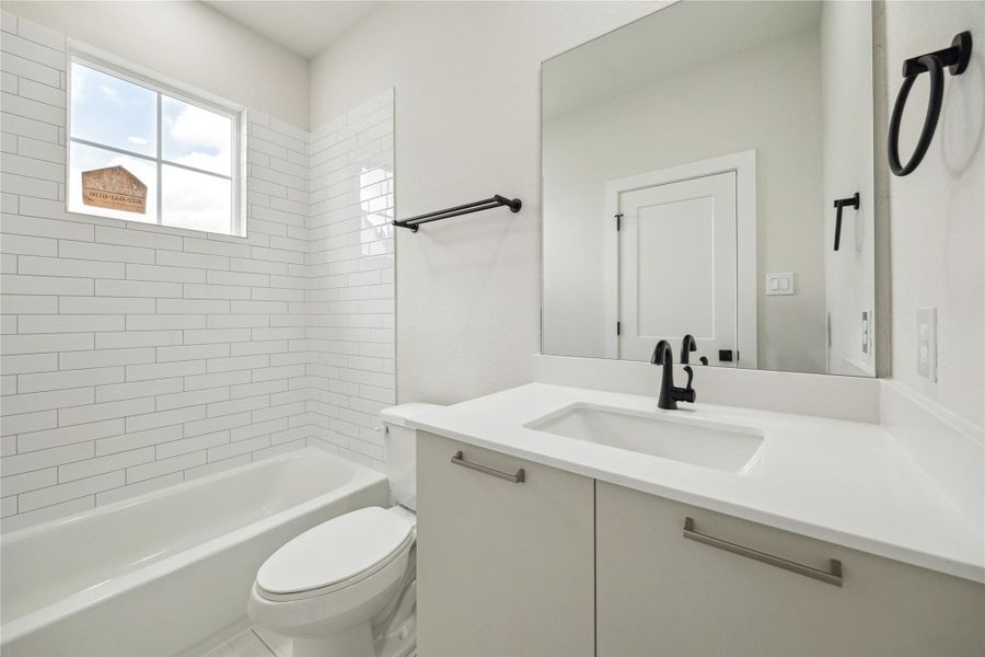 Bright and modern third-floor bathroom featuring sleek fixtures and a stylish, tiled shower.