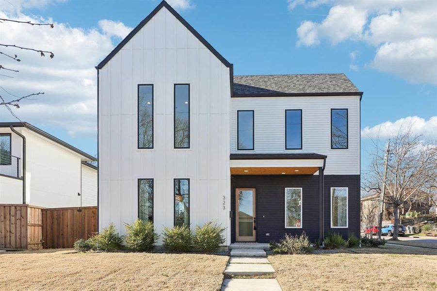 Modern inspired farmhouse featuring a front lawn