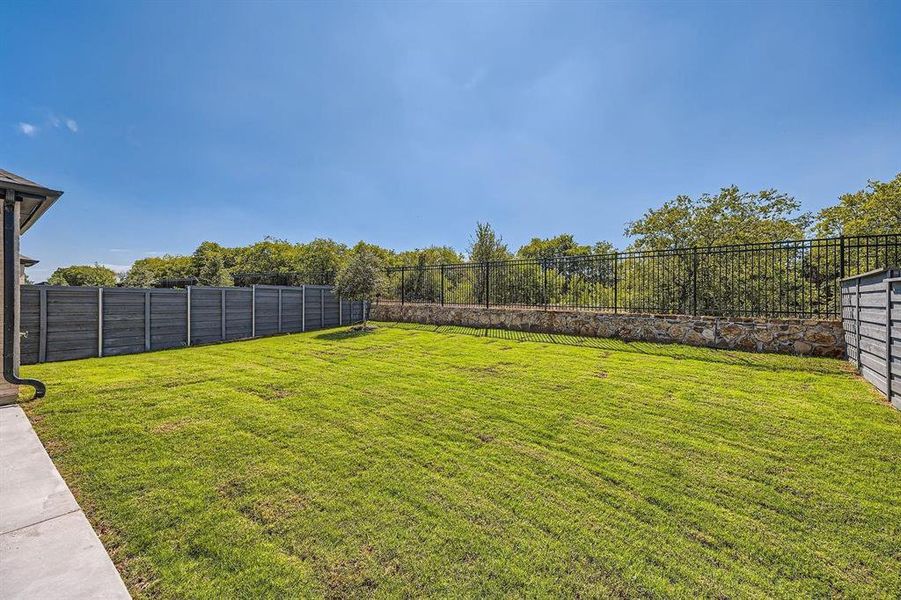 Expansive backyard featuring a lush lawn Expansive backyard featuring a lush lawn