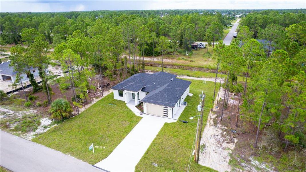 Front exterior of a new home in , Lehigh Acres, FL, highlighting curb appeal (Image 28).