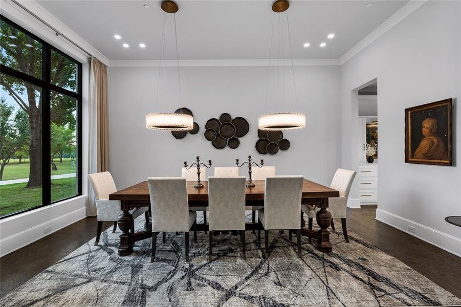 Dining area featuring dark hardwood / wood floors, ornamental molding, and a wealth of natural light