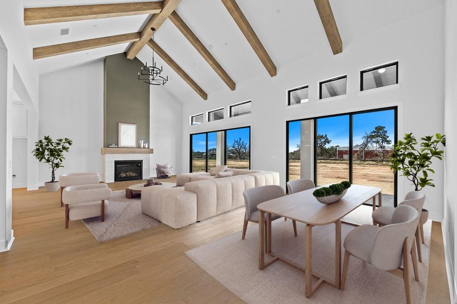 *Virtually Staged* Living area with light wood-style flooring and a glass covered fireplace