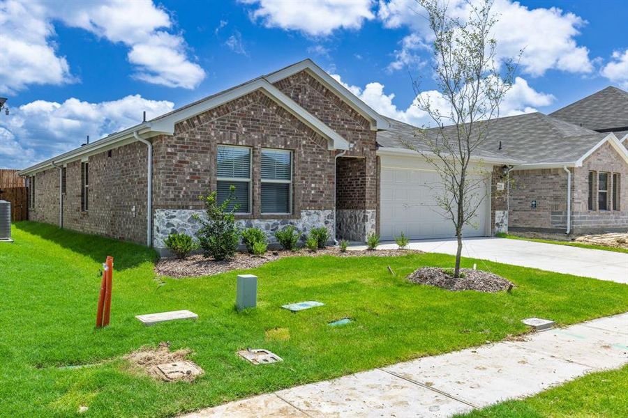Front exterior of a new home in Stratton Place, Greenville, TX, highlighting curb appeal (Image 1). Front exterior of a new home in Stratton Place, Greenville, TX, highlighting curb appeal (Image 1).