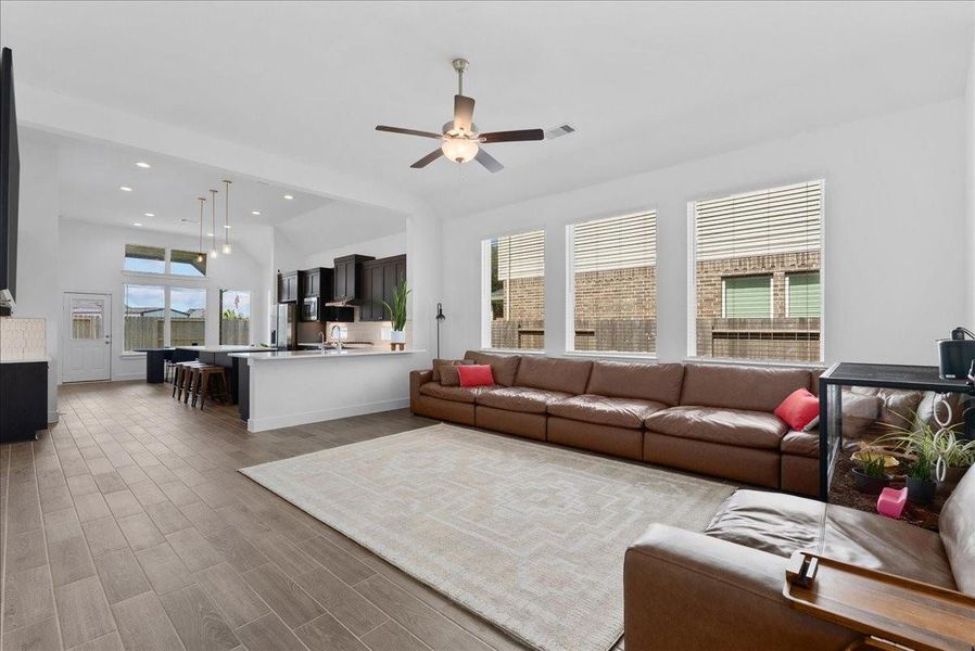 The spacious family room offers a seamless view into the kitchen and dining area, creating an open and inviting space perfect for everyday living and entertaining. The spacious family room offers a seamless view into the kitchen and dining area, creating an open and inviting space perfect for everyday living and entertaining.