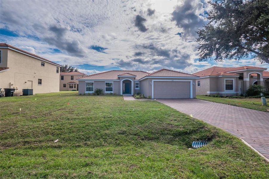 Front exterior of a new home in , Kissimmee, FL, highlighting curb appeal (Image 21).