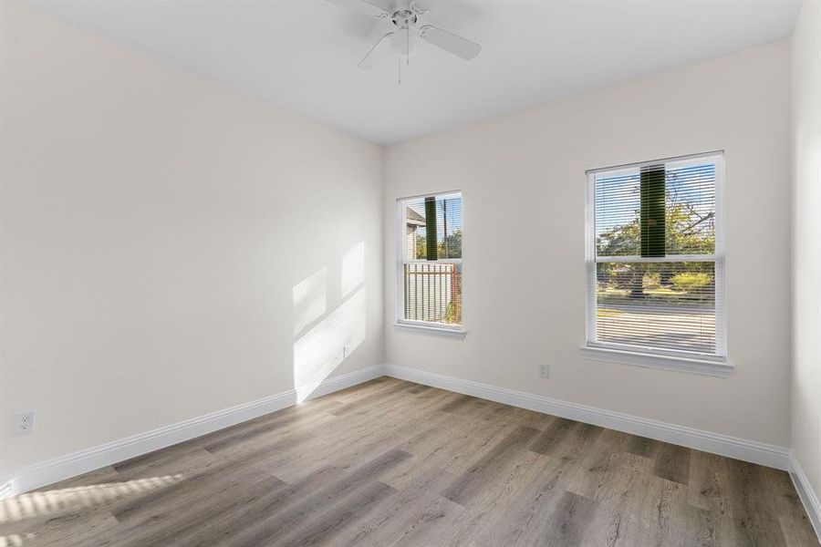 Unfurnished room with light wood-type flooring and ceiling fan