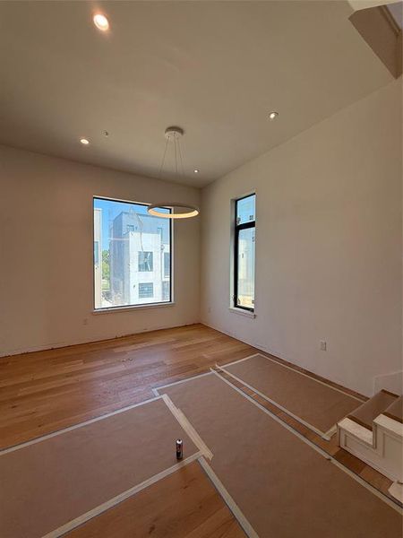 Unfurnished dining area with light wood-type flooring and recessed lighting