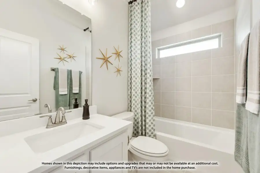 Full bathroom with white vanity, tub-shower combo with tile surround, and small window