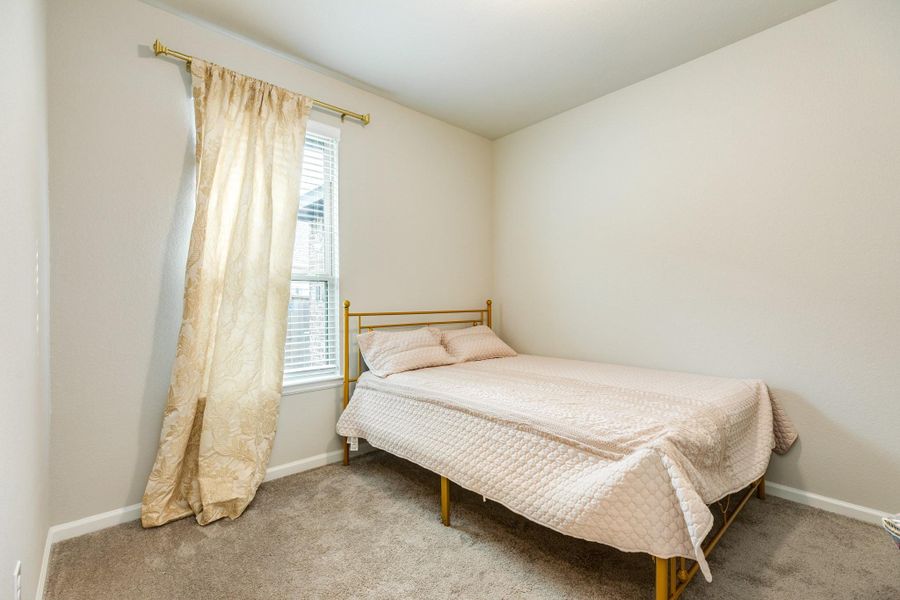 Secondary bedroom featuring a large window and boasting excellent, like-new carpet. Secondary bedroom featuring a large window and boasting excellent, like-new carpet.