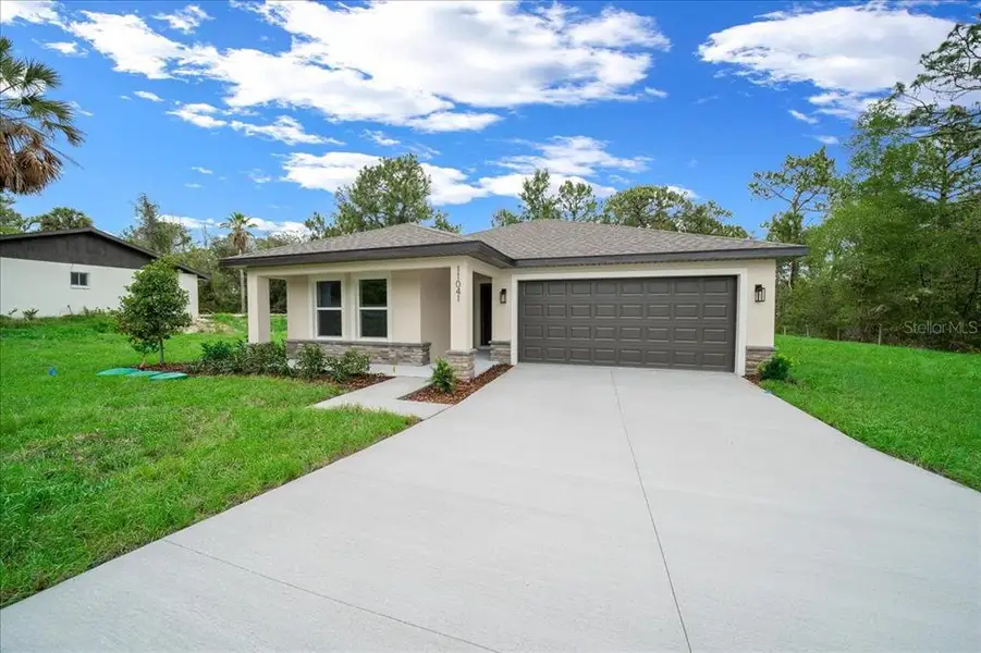 Front exterior of a new home in , Weeki Wachee, FL, highlighting curb appeal (Image 24).