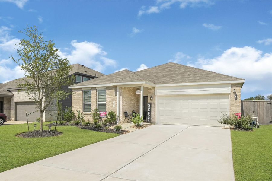 Charming single-story home with a welcoming front porch, manicured lawn, and spacious two-car garage. Charming single-story home with a welcoming front porch, manicured lawn, and spacious two-car garage.