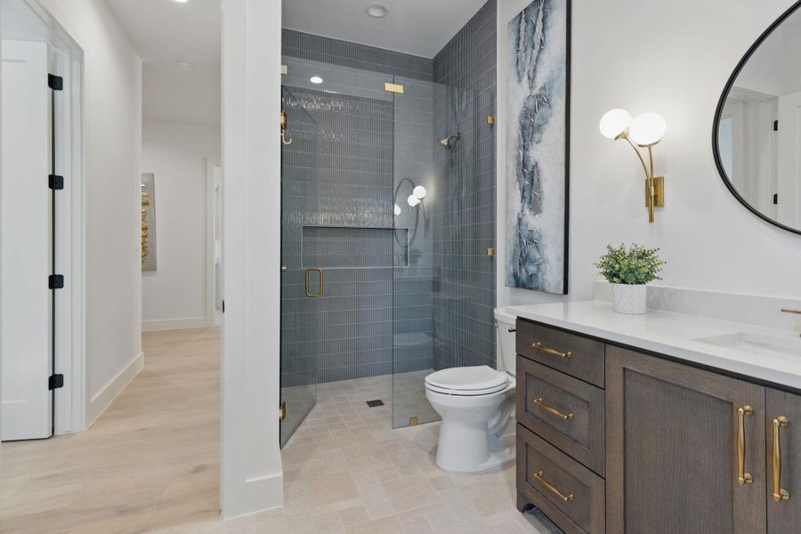 Bathroom featuring vanity, a stall shower, and recessed lighting