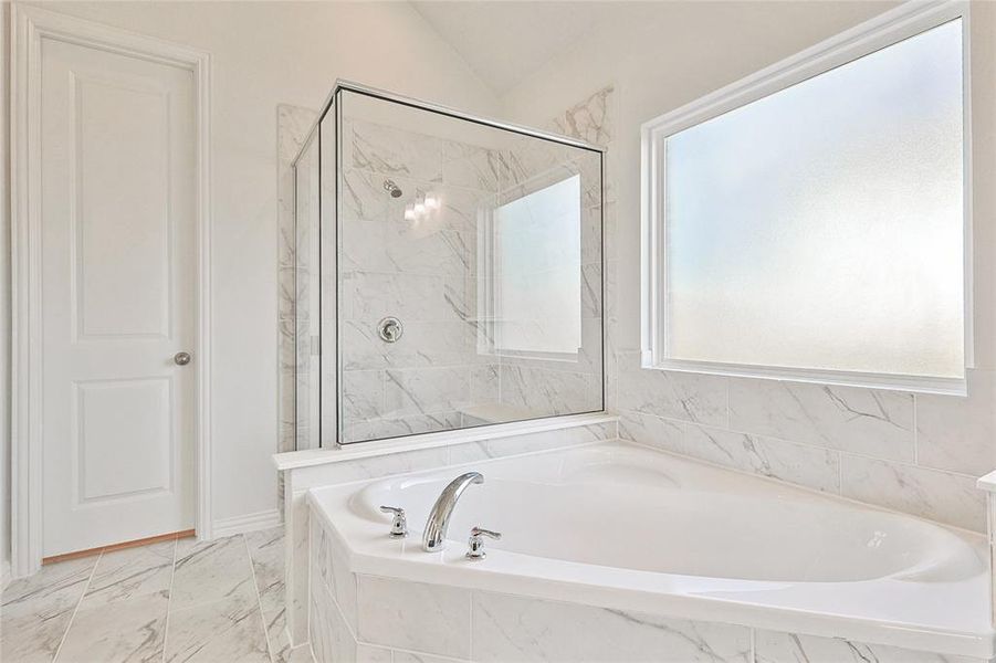 Bathroom featuring plus walk in shower and tile patterned floors