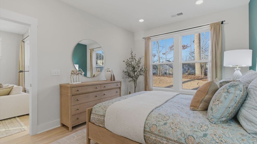 Eye-catching details and elegant finishes in the vibrant primary suite of this select villa in Greenville, SC