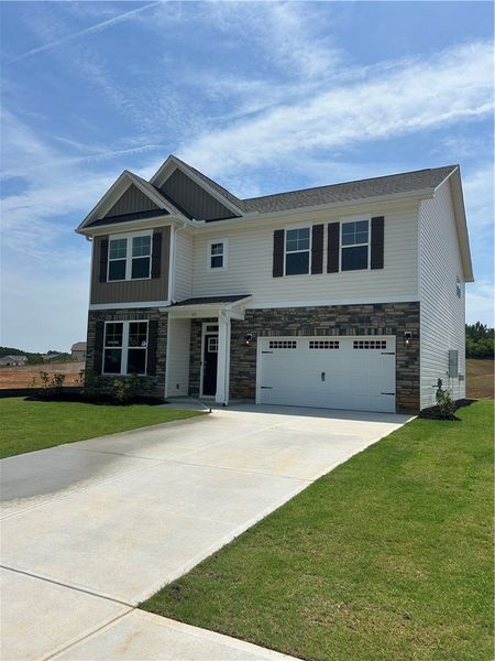 A classic facade combining stone and siding with a