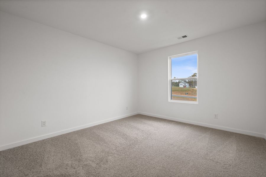 A room with a window and a carpet. A room with a window and a carpet.