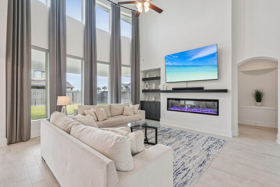 Stunning high ceilings, custom drapes and remote controlled shades, custom cabinets installed, remote controlled electric fire place.