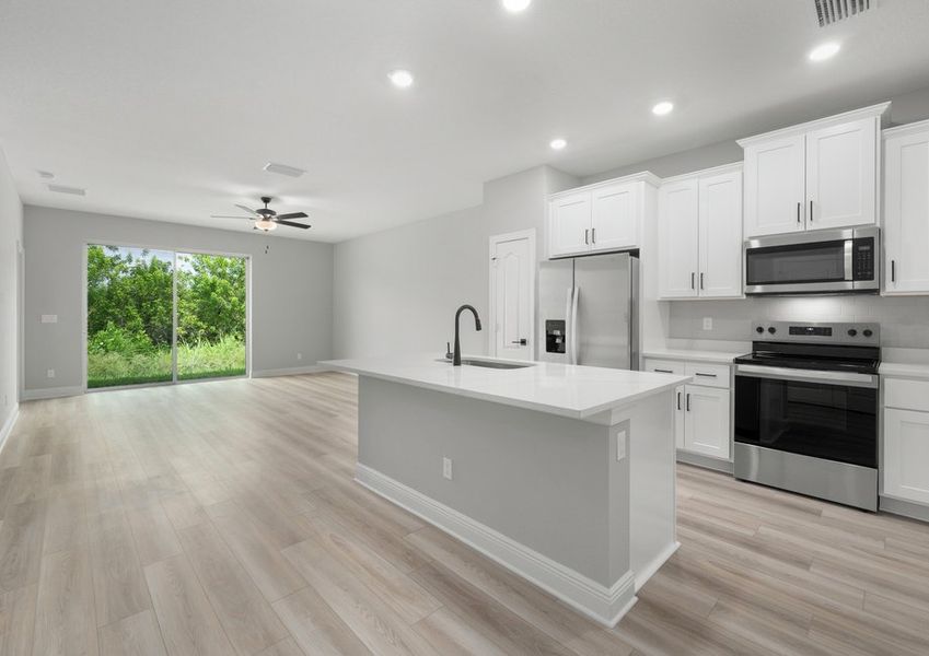 Kitchen with a large island and the family room