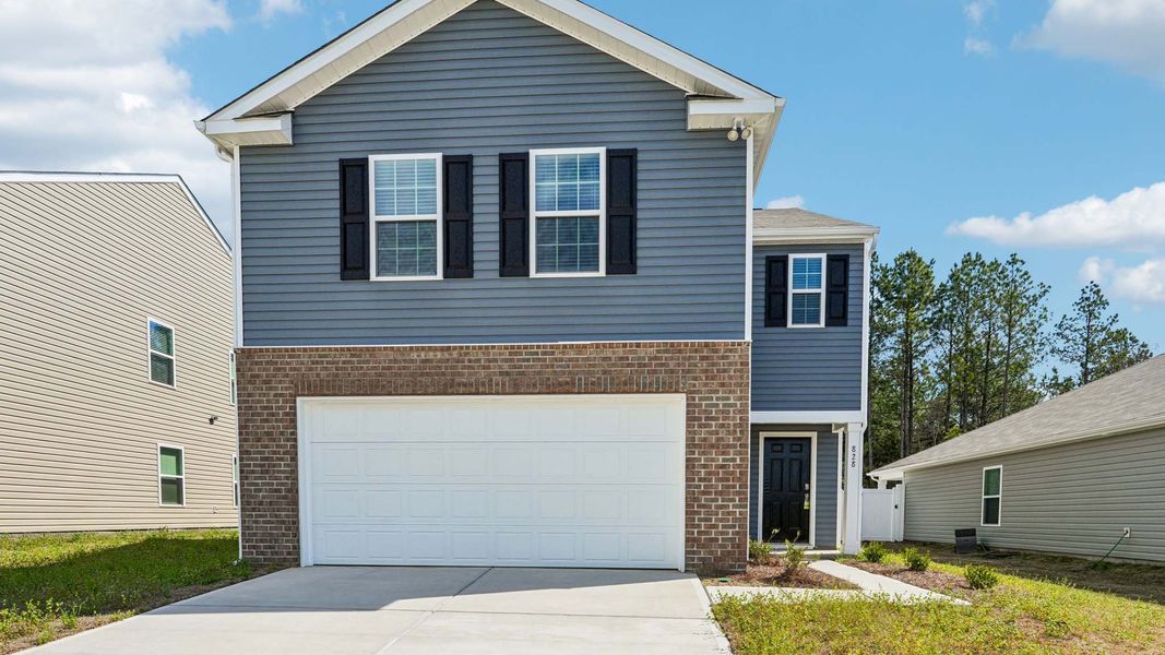 Front exterior of a new home in Woodhaven at Chester, Chester, SC, highlighting curb appeal (Image 1). Front exterior of a new home in Woodhaven at Chester, Chester, SC, highlighting curb appeal (Image 1).