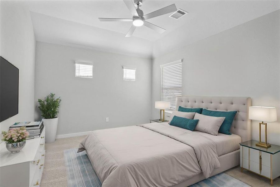 Secondary bedroom features plush carpet, custom paint, high ceilings with ceiling fan and a large window with privacy blinds.