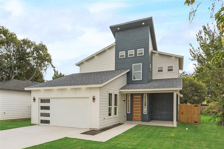 Contemporary home with roof with shingles, concrete driveway, and covered porch Contemporary home with roof with shingles, concrete driveway, and covered porch