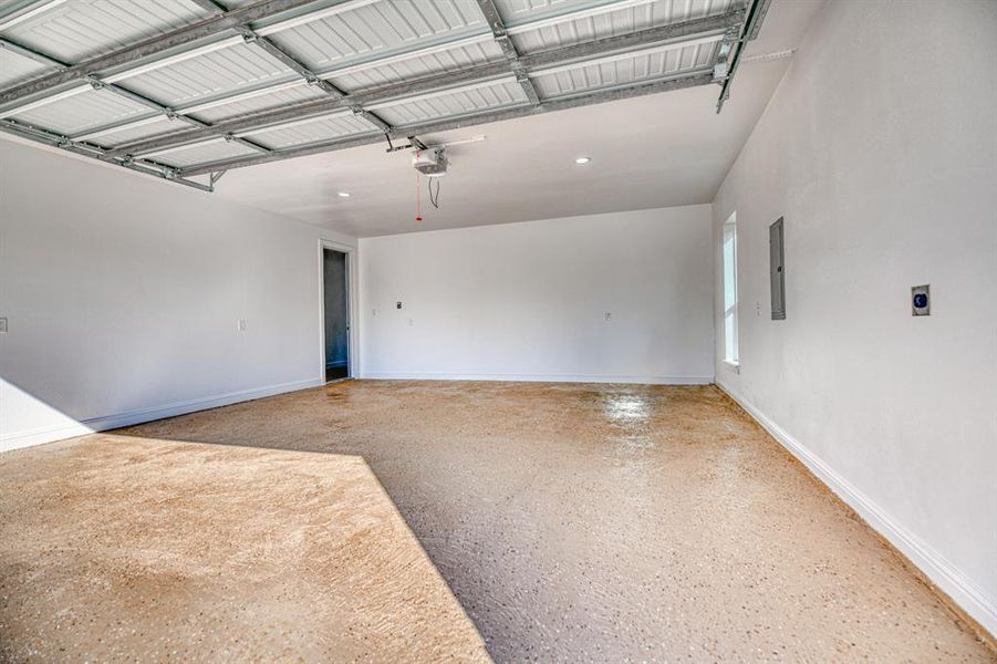 Garage with electric panel and a garage door opener