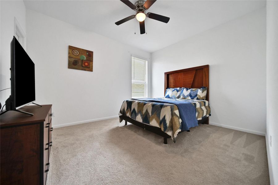 sedondary bedroom offers ceiling fan and walk in closet