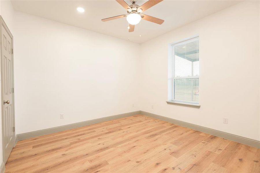 Spare room with light wood finished floors, recessed lighting, and ceiling fan